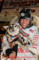 Aliy Zirkle holds up her lead dog Quito shortly after finishing in second place for the 2014 Iditarod in Nome on Tuesday, March 11, during the Iditarod Sled Dog Race 2014.PHOTO (c) BY JEFF SCHULTZ/IditarodPhotos.com -- REPRODUCTION PROHIBITED WITHOUT PERMISSION