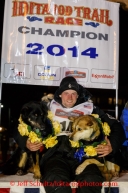 Dallas Seavey poses on the winner's stand with his lead dogs Beatle (L) and Reef after winning the 2014 Iditarod in record time of 8 days 13 hours 4 minutes and 19 seconds.   Tuesday, March 11, 2014.  Iditarod Sled Dog Race 2014.PHOTO (c) BY JEFF SCHULTZ/IditarodPhotos.com -- REPRODUCTION PROHIBITED WITHOUT PERMISSION