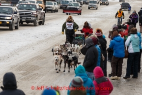 Sonny Lindner runs down Front Street with his 10 year old son Sam on his sled into Nome to finish in 5th place on Tuesday March 11th during the 2014 Iditarod Sled Dog Race.PHOTO (c) BY JEFF SCHULTZ/IditarodPhotos.com -- REPRODUCTION PROHIBITED WITHOUT PERMISSION