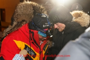 Third place finisher, Mitch Seavey, talks with his son Dallas who hours before won the 2014 Iditarod in record time at the Nome finish line on Tuesday March 11th during the 2014 Iditarod Sled Dog Race.PHOTO (c) BY JEFF SCHULTZ/IditarodPhotos.com -- REPRODUCTION PROHIBITED WITHOUT PERMISSION