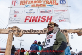 Sonny Lindner at the burl arch finish line at Nome after finishing in 5th place on Tuesday March 11th during the 2014 Iditarod Sled Dog Race.PHOTO (c) BY JEFF SCHULTZ/IditarodPhotos.com -- REPRODUCTION PROHIBITED WITHOUT PERMISSION