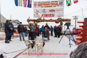 Ray Redington Jr. with his kids on the sled, takes his dogs out of the finish chute in Nome after finishing in 8th place on Tuesday March 11th during the 2014 Iditarod Sled Dog Race.PHOTO (c) BY JEFF SCHULTZ/IditarodPhotos.com -- REPRODUCTION PROHIBITED WITHOUT PERMISSION
