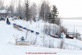 Lachlan Clarke runs down the bank of the Yukon river at the Tanana checkpoint on Wednesday morning  March 11th during the 2015 Iditarod.(C) Jeff Schultz/SchultzPhoto.com - ALL RIGHTS RESERVED DUPLICATION  PROHIBITED  WITHOUT  PERMISSION