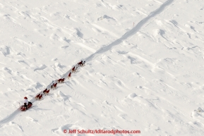 A team crosses through snow-covered jumbled Yukon River ice on the trail between Tanana and Ruby on Wednesday afternoon  March 11th during the 2015 Iditarod.(C) Jeff Schultz/SchultzPhoto.com - ALL RIGHTS RESERVED DUPLICATION  PROHIBITED  WITHOUT  PERMISSION