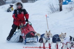 Aliy Zirkle moves to a parking spot dragging her food bags after checking in at the Ruby checkpoint on March 11, 2015 during Iditarod 2015.(C) Jeff Schultz/SchultzPhoto.com - ALL RIGHTS RESERVED DUPLICATION  PROHIBITED  WITHOUT  PERMISSION