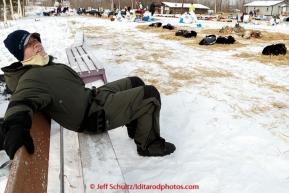 Volunteer Jeff Walters sits on a park bench as he awaits another team's arrival on the banks of the Yukon river at the Tanana checkpoint on Wednesday afternoon March 11th during the 2015 Iditarod.(C) Jeff Schultz/SchultzPhoto.com - ALL RIGHTS RESERVED DUPLICATION  PROHIBITED  WITHOUT  PERMISSION