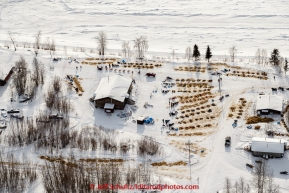 As Cindy Abbott checks in, other teams rest on straw outside the community center at the Yukon River checkpoint at Tanana on Wednesday afternoon  March 11th during the 2015 Iditarod.(C) Jeff Schultz/SchultzPhoto.com - ALL RIGHTS RESERVED DUPLICATION  PROHIBITED  WITHOUT  PERMISSION