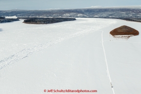 A team runs down the trail on the Yukon River between Tanana and Ruby on Wednesday afternoon  March 11th during the 2015 Iditarod.(C) Jeff Schultz/SchultzPhoto.com - ALL RIGHTS RESERVED DUPLICATION  PROHIBITED  WITHOUT  PERMISSION