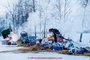 Lachlan Clarke and Ben Harper prepare food for their dogs on the banks of the Yukon river at the Tanana checkpoint on Wednesday morning  March 11th during the 2015 Iditarod(C) Jeff Schultz/SchultzPhoto.com - ALL RIGHTS RESERVED DUPLICATION  PROHIBITED  WITHOUT  PERMISSION