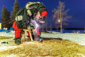 Scott Janssen boots his on the banks of the Yukon river at the Tanana checkpoint prior to departin on Wednesday morning  March 11th during the 2015 Iditarod.(C) Jeff Schultz/SchultzPhoto.com - ALL RIGHTS RESERVED DUPLICATION  PROHIBITED  WITHOUT  PERMISSION