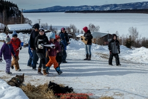 Ruby School children take a field trip for a scavenger hunt and to see the Iditarod dogs along the main street of the village at the Ruby Checkpoint during the 2016 Iditarod.  March 11, 2016   Photo by Jeff Schultz (C) 2016  ALL RIGHTS RESERVED