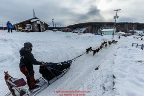 Richile Diehl runs down the road as he leaves the Ruby Checkpoint during the 2016 Iditarod.  March 11, 2016    Photo by Jeff Schultz (C) 2016  ALL RIGHTS RESERVED
