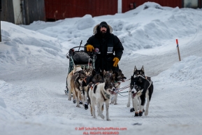 Cim Smyth runs up the road at the Ruby Checkpoint during the 2016 Iditarod.  March 11, 2016    Photo by Jeff Schultz (C) 2016  ALL RIGHTS RESERVED