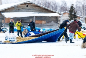 Volunteers move straw at the Huslia checkpoint during the 2017 Iditarod on Saturday morning March 11, 2017.  Photo by Jeff Schultz/SchultzPhoto.com  (C) 2017  ALL RIGHTS RESERVED