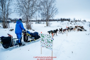 Ketil Reitan runs down the road and past encouraging signs on the trail out of  the Huslia checkpoint during the 2017 Iditarod on Saturday morning March 11, 2017.Photo by Jeff Schultz/SchultzPhoto.com  (C) 2017  ALL RIGHTS RESERVED