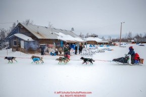 Ryan Redington runs past the Tribal Council building as he leaves  the Huslia checkpoint during the 2017 Iditarod on Saturday morning March 11, 2017.Photo by Jeff Schultz/SchultzPhoto.com  (C) 2017  ALL RIGHTS RESERVED