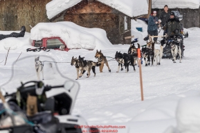 Tom Knolmayer runs down the street and into the Kaltag village checkpoint on Sunday afternoon March 11th during the 2018 Iditarod Sled Dog Race -- AlaskaPhoto by Jeff Schultz/SchultzPhoto.com  (C) 2018  ALL RIGHTS RESERVED