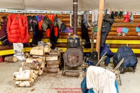 Musher gear is hung up to dry around the wood stove in the community center at the Kaltag village checkpoint on Sunday morning March 11th during the 2018 Iditarod Sled Dog Race -- AlaskaPhoto by Jeff Schultz/SchultzPhoto.com  (C) 2018  ALL RIGHTS RESERVED