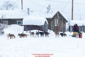 Aaron Burmeister runs down the road as he leaves the Kaltag village checkpoint on Sunday morning March 11th during the 2018 Iditarod Sled Dog Race -- AlaskaPhoto by Jeff Schultz/SchultzPhoto.com  (C) 2018  ALL RIGHTS RESERVED