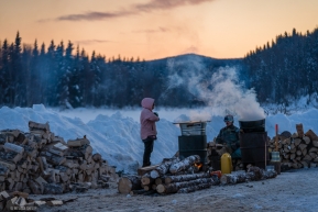 Volunteers keep water available for incoming dog teams to use for warm meals in Takotna, Alaska on March 11, 2020.