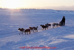 Sunday March 11, 2012  Kelly Griffin arrives as the sun rises at Unalakleet. Iditarod 2012.