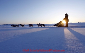 Sunday March 11, 2012  Hugh Neff runs on the slough as the sun rises at Unalakleet. Iditarod 2012.