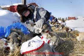 Sunday March 11, 2012   Volunteer veterinarian Mike Hicks works with an Aliy Zirkle dog at Elim. Iditarod 2012.