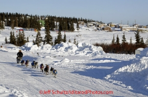 Sunday March 11, 2012  Aaron Burmeister runs on the road in Elim as he nears the checkpoint. Iditarod 2012.