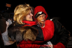 Mitch Seavey, right, 53, gets a hug and kiss from his wife, Janine, after pulling into Nome first and winning his second Iditarod sled dog race on Tuesday March 12, 2013. Seavey made the journey from Willow in 9 days, 7 hours, 39 minutes, 56 seconds. Iditarod Sled Dog Race 2013Photo by Jeff Schultz copyright 2013 DO NOT REPRODUCE WITHOUT PERMISSION