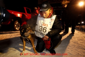 Mitch Seavey, right, 53, pets one of his lead dogs, Tanner, after pulling into Nome first and winning his second Iditarod sled dog race on Tuesday March 12, 2013. Seavey made the journey from Willow in 9 days, 7 hours, 39 minutes, 56 seconds. Iditarod Sled Dog Race 2013Photo by Jeff Schultz copyright 2013 DO NOT REPRODUCE WITHOUT PERMISSION