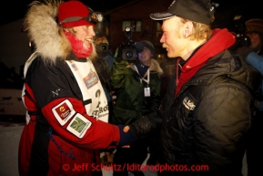Aily Zirkle, left, shakes hands with Iditarod winner Mitch Seavey after she pulled into Nome minutes after him on Tuesday March 12, 2013.Iditarod Sled Dog Race 2013Photo by Jeff Schultz copyright 2013 DO NOT REPRODUCE WITHOUT PERMISSION