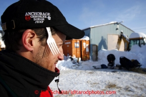 Volunteer veterinarian Scott Rosenbloom has the neccessary gear in his hat as he waits for a team at the Elim checkpoint on Tuesday March 12, 2013.Iditarod Sled Dog Race 2013Photo by Jeff Schultz copyright 2013 DO NOT REPRODUCE WITHOUT PERMISSION