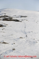 Two teams run down the hills on their way toward Golovin on Tuesday March 12, 2013.Iditarod Sled Dog Race 2013Photo by Jeff Schultz copyright 2013 DO NOT REPRODUCE WITHOUT PERMISSION