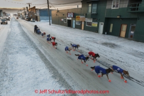 Michelle Philips runs down Front Street in Nome on her way to a 20th place finish on Wednesday March 12, during the 2014 Iditarod Sled Dog Race.PHOTO (c) BY JEFF SCHULTZ/IditarodPhotos.com -- REPRODUCTION PROHIBITED WITHOUT PERMISSION