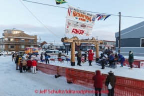 Michelle Philips team at the Nome finish line on Front Street on on Wednesday March 12, during the 2014 Iditarod Sled Dog Race.PHOTO (c) BY JEFF SCHULTZ/IditarodPhotos.com -- REPRODUCTION PROHIBITED WITHOUT PERMISSION