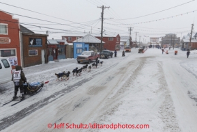 Robert Sorlie runs on Front Street toward the burl arch finish line on Front Srteet in Nome on Wednesday March 12, during the 2014 Iditarod Sled Dog Race.PHOTO (c) BY JEFF SCHULTZ/IditarodPhotos.com -- REPRODUCTION PROHIBITED WITHOUT PERMISSION