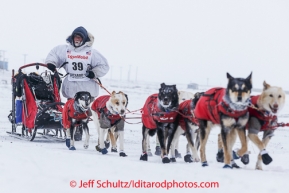 Jason Mackey runs next to his sled as he travels on the trail nearing Nome on Thursday March 13 during the 2014 Iditarod Sled Dog Race.PHOTO (c) BY JEFF SCHULTZ/IditarodPhotos.com -- REPRODUCTION PROHIBITED WITHOUT PERMISSION