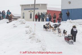 Justin Savidas runs up the ramp off the Bering Sea at Nome  just a half-mile from the finish line on Thursday March 13 during the 2014 Iditarod Sled Dog Race.PHOTO (c) BY JEFF SCHULTZ/IditarodPhotos.com -- REPRODUCTION PROHIBITED WITHOUT PERMISSION