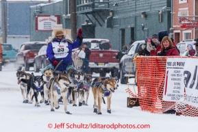 Karin Hendrickson runs into the finish chute at Nome on Thursday March 13 during the 2014 Iditarod Sled Dog Race.PHOTO (c) BY JEFF SCHULTZ/IditarodPhotos.com -- REPRODUCTION PROHIBITED WITHOUT PERMISSION
