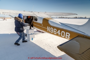 At the Galena airport, volunteer pilot Russ Dunlap loads people food boxes headed for Nulato into a plane flown by Dave Looney in the afternoon on Thursday March 12, 2015 during the 2015 Iditarod (C) Jeff Schultz/SchultzPhoto.com - ALL RIGHTS RESERVED DUPLICATION  PROHIBITED  WITHOUT  PERMISSION