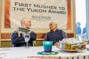 Jeff King shares his Millenium Hotel first musher to the Yukon dinner award with Paddy Nollner at Galena on Thursday March 12, 2015 during Iditarod 2015.  Paddy is the son of original 1925 serum musher Edgar Nollner.  (C) Jeff Schultz/SchultzPhoto.com - ALL RIGHTS RESERVED DUPLICATION  PROHIBITED  WITHOUT  PERMISSION