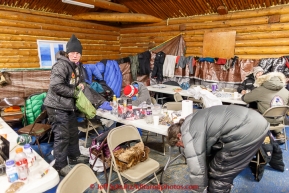 Jodi Bailey packs some gear inside the commmunity center in the morning on Thursday March 12, 2015 at the Ruby checkpoint during Iditarod 2015.(C) Jeff Schultz/SchultzPhoto.com - ALL RIGHTS RESERVED DUPLICATION  PROHIBITED  WITHOUT  PERMISSION