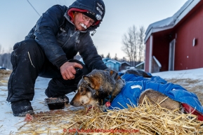 Mitch Seavey sprays an essential oil on one of his dogs in the morning on Thursday March 12, 2015 at the Ruby checkpoint during Iditarod 2015.(C) Jeff Schultz/SchultzPhoto.com - ALL RIGHTS RESERVED DUPLICATION  PROHIBITED  WITHOUT  PERMISSION