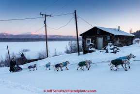 Jim Lanier runs up the hill in the morning on Thursday March 12, 2015 as he arrives at the Ruby checkpoint during Iditarod 2015.(C) Jeff Schultz/SchultzPhoto.com - ALL RIGHTS RESERVED DUPLICATION  PROHIBITED  WITHOUT  PERMISSION