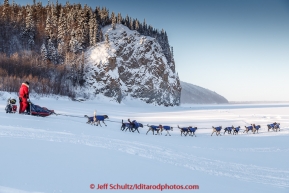 Charley Benja drops onto the Yukon River in the morning on Thursday March 12, 2015 after leaving the Ruby checkpoint during Iditarod 2015.(C) Jeff Schultz/SchultzPhoto.com - ALL RIGHTS RESERVED DUPLICATION  PROHIBITED  WITHOUT  PERMISSION