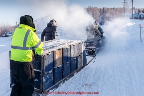 Volunteer Billy Honea helps push a sled load of dropped dogs towards the airport in the morning on Thursday March 12, 2015 at the Ruby checkpoint during Iditarod 2015.(C) Jeff Schultz/SchultzPhoto.com - ALL RIGHTS RESERVED DUPLICATION  PROHIBITED  WITHOUT  PERMISSION