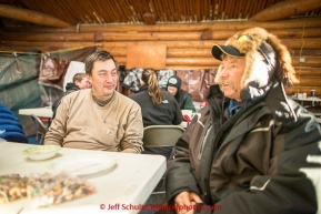 John Baker talks with Sonny Lindner inside the community hall in Ruby on Thursday March 12, 2015 during Iditarod 2015. Sonny is not running the race this year, but was in Ruby doing a work project. (C) Jeff Schultz/SchultzPhoto.com - ALL RIGHTS RESERVED DUPLICATION  PROHIBITED  WITHOUT  PERMISSION