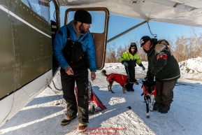 Pilot O.E. Robbins is ready to load the dropped dogs vet Roger Troutman and pilot Daniel Hayden are bringing his way at the Ruby Checkpoint on Saturday March 12th during the 2016 Iditarod.  Alaska    Photo by Jeff Schultz (C) 2016  ALL RIGHTS RESERVED