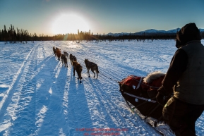 Hugh Neff runs down the trail after leaving the Kaltag checkpoint near sunset on Saturday March 12th during the 2016 Iditarod.  Alaska    Photo by Jeff Schultz (C) 2016  ALL RIGHTS RESERVED