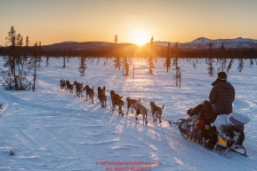 Noah Burmeister and team run down the trail near sunset after leaving the Kaltag checkpoint on Saturday March 12th during the 2016 Iditarod.  Alaska    Photo by Jeff Schultz (C) 2016  ALL RIGHTS RESERVED
